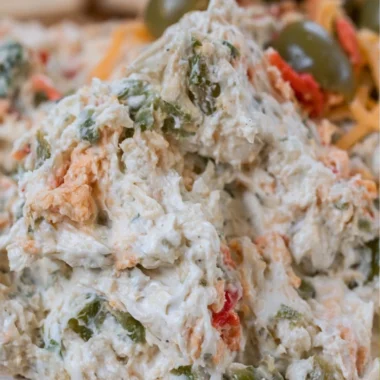 Delicious olive dip served in a bowl with bread for dipping.