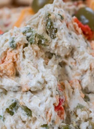 Delicious olive dip served in a bowl with bread for dipping.