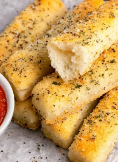 Golden brown sheet pan breadsticks ready to serve with a meal.