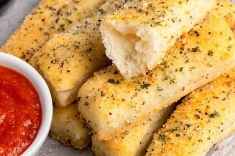 Golden brown sheet pan breadsticks ready to serve with a meal.