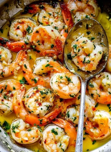Delicious shrimp scampi with garlic, parsley, and lemon served over pasta.
