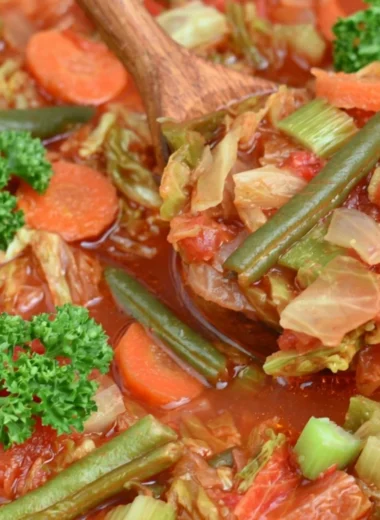 A warm bowl of cabbage soup for weight loss with fresh ingredients.