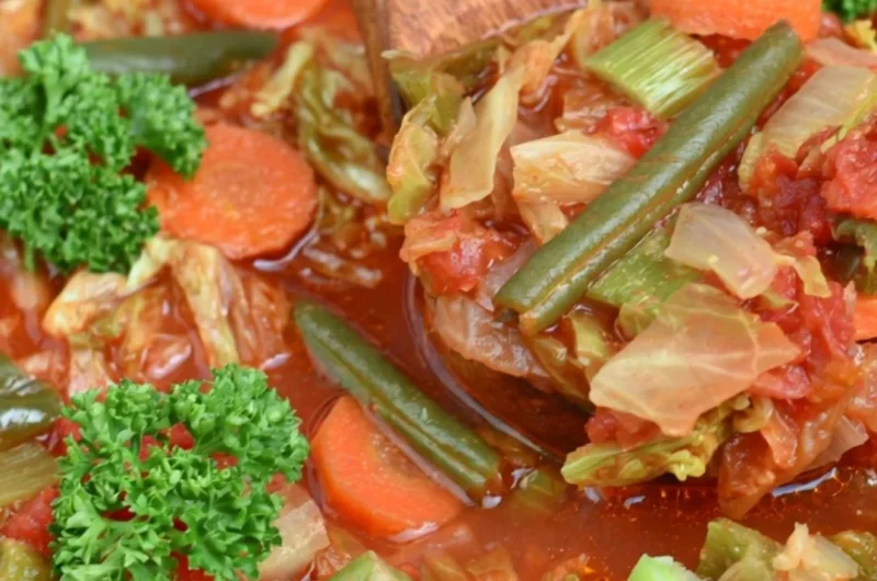 A warm bowl of cabbage soup for weight loss with fresh ingredients.