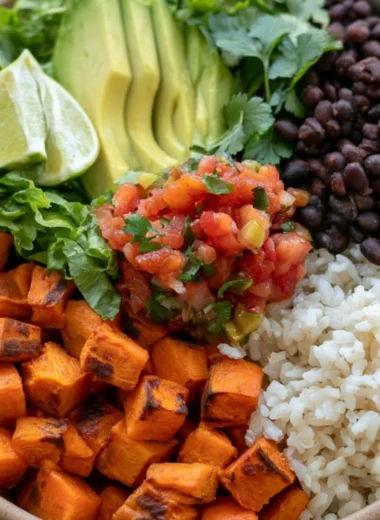 Cozy black bean sweet potato burrito bowls topped with fresh ingredients