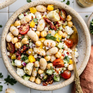 Cozy dense bean salad filled with various beans and fresh vegetables.