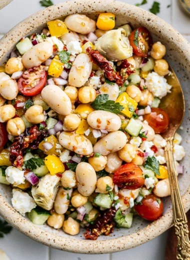 Cozy dense bean salad filled with various beans and fresh vegetables.