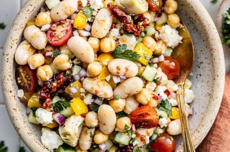 Cozy dense bean salad filled with various beans and fresh vegetables.