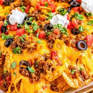 Delicious cozy sheet pan nachos topped with cheese and toppings