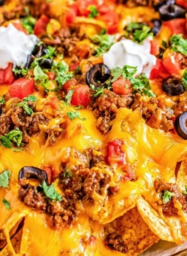 Delicious cozy sheet pan nachos topped with cheese and toppings