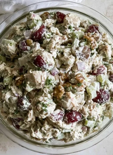 Healthy chicken salad without mayo served in a bowl, garnished with herbs.