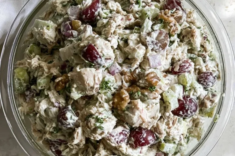 Healthy chicken salad without mayo served in a bowl, garnished with herbs.