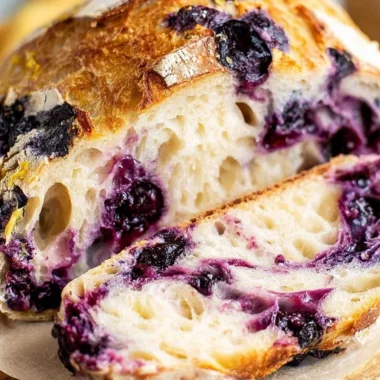 Lemon Blueberry Sourdough Bread fresh out of the oven with blueberries and lemon slices