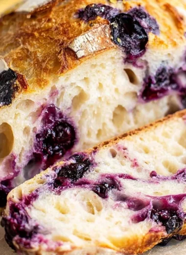 Lemon Blueberry Sourdough Bread fresh out of the oven with blueberries and lemon slices