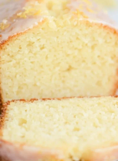 Sourdough Discard Lemon Cake topped with lemon glaze and fresh zest