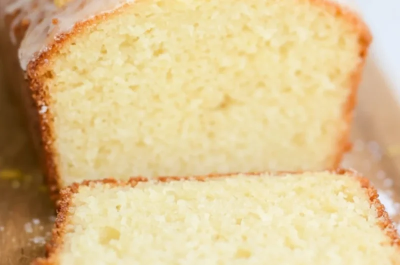 Sourdough Discard Lemon Cake topped with lemon glaze and fresh zest