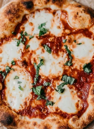 Homemade sourdough pizza crust topped with fresh ingredients