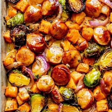 Easy sheet pan sausage and veggies with maple Dijon sauce on a baking tray