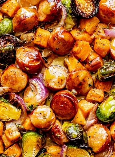 Easy sheet pan sausage and veggies with maple Dijon sauce on a baking tray